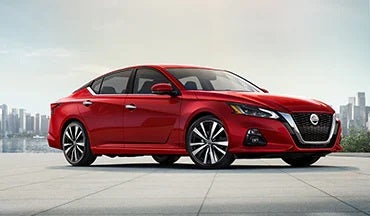 2023 Nissan Altima in red with city in background illustrating last year's 2022 model in Cole Nissan in Pocatello ID