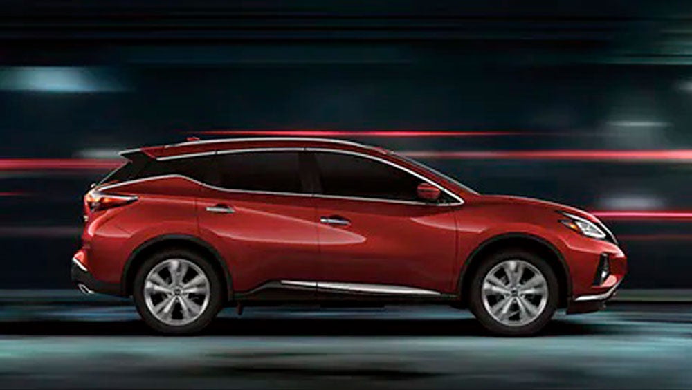 2023 Nissan Murano shown in profile driving down a street at night illustrating performance. | Cole Nissan in Pocatello ID